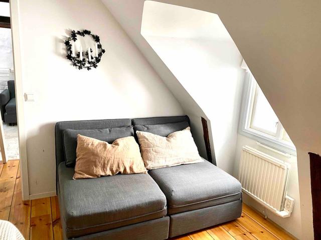 Loft apartment in Stockholm's Old Town with wooden beams.