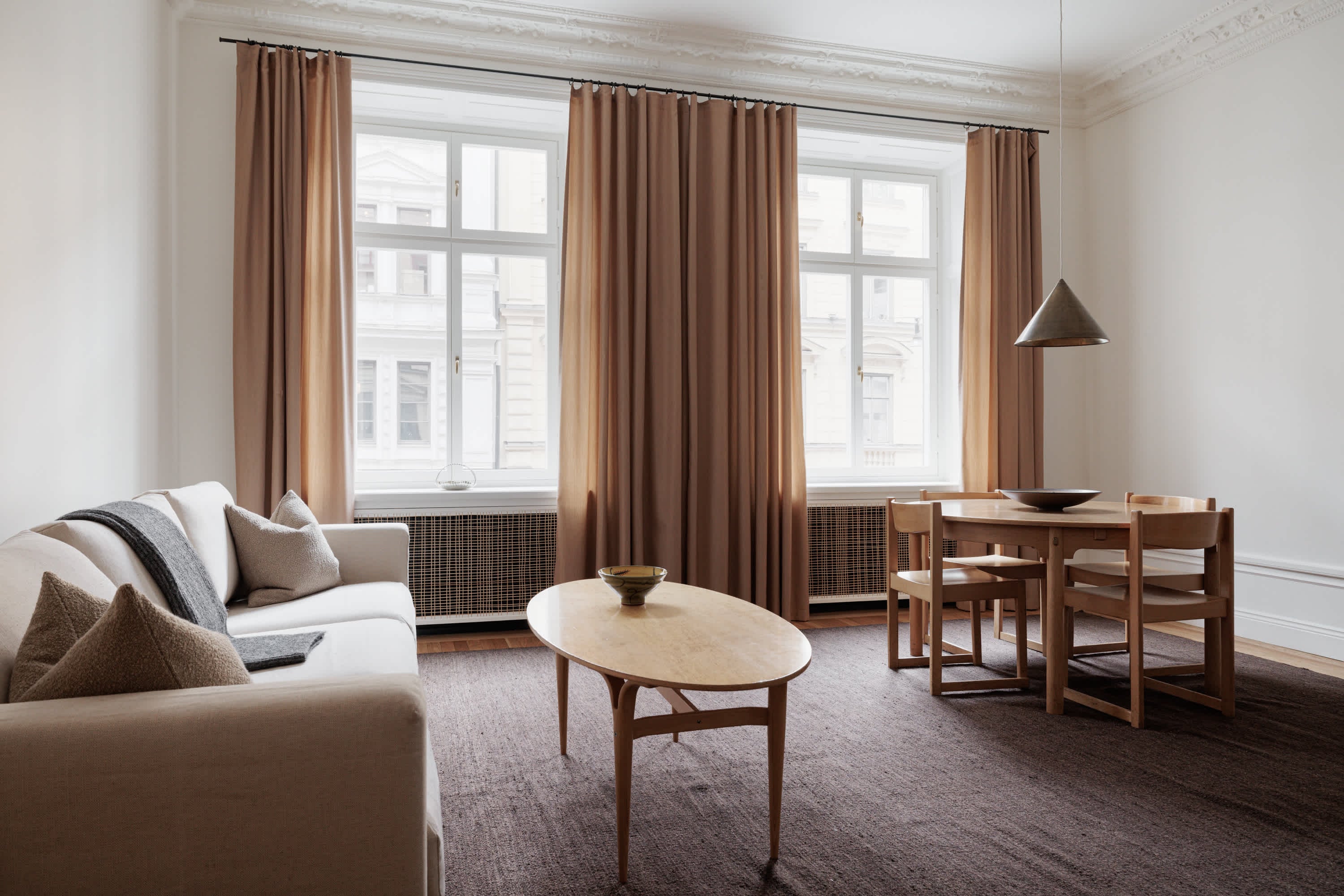 Interior of stylish apartment in Östermalm, Stockholm, with open-plan layout, wooden floors & marble bathroom